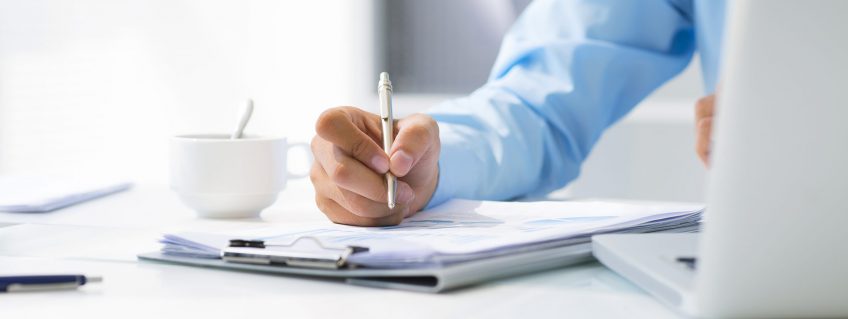 Close-up-of-male-hand-making-notes-in-office-1920x1281